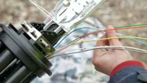 Inneos | Busting Myths about Fiber Optic Cables Technicians installing optic fiber with cable ties.