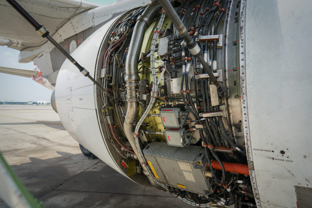Inneos | Exploring the Hidden Benefits of Using Fiber Cables in Electric Aircraft Fan cowl are opened to show inside an electric aircraft jet engine