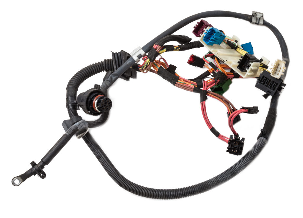 Inneos | Automotive Optical Ethernet A cable of matted wires of different colors with connectors in the electrical wiring of the car.
